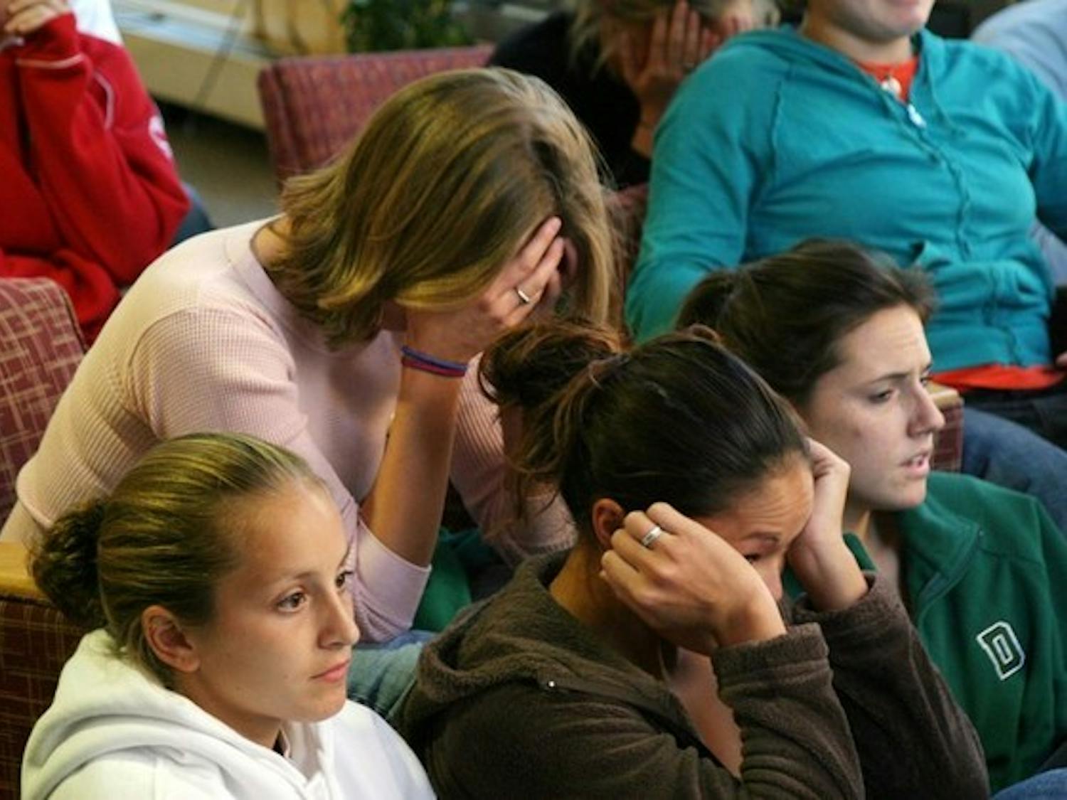 Women's soccer team members, watching the selection results in Collis, react to their NCAA tourney snub.