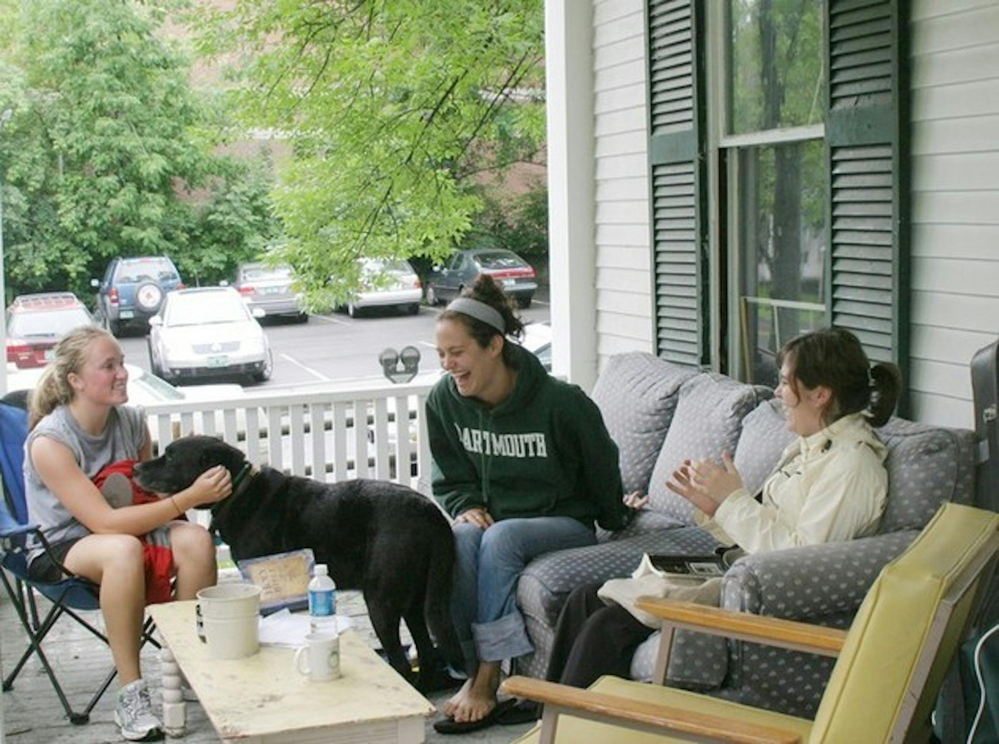 From left, Kate Labrum '08, house dog Sam, Haley Morris '08, and Alyson Guillet '08 relax on the porch of their off-campus house at 8 School Street.