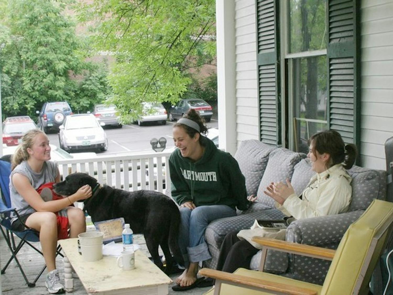 From left, Kate Labrum '08, house dog Sam, Haley Morris '08, and Alyson Guillet '08 relax on the porch of their off-campus house at 8 School Street.