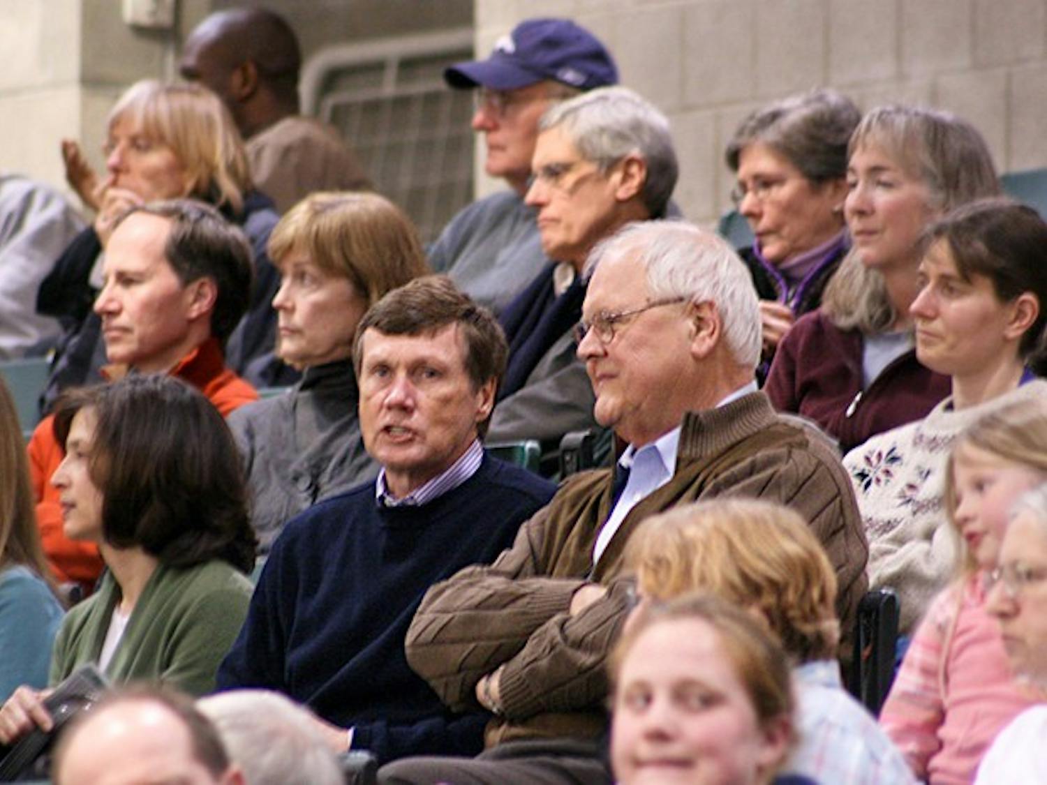 Board Chairman Ed Haldeman '70 and College President James Wright watch the women's basketball team defeat Columbia on Saturday night.