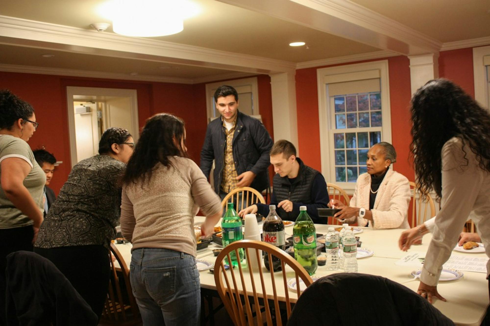 Students gather in Triangle House for a dinner during LGBTQIA+ History Month.&nbsp;