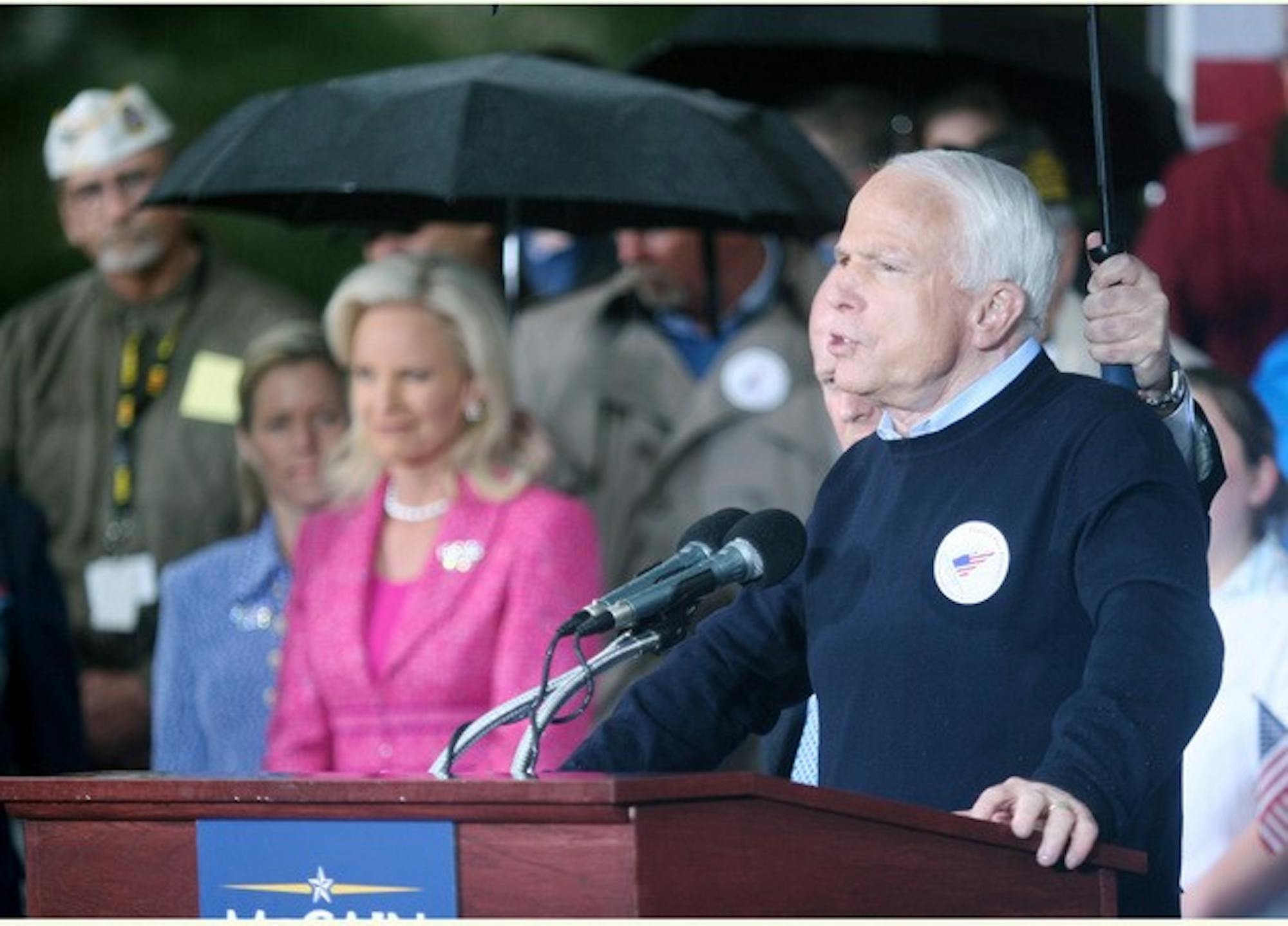 Sheltered from the rain, Sen. John McCain, R-Ariz., speaks to a crowd of 200 in Veteran Memorial Park in Manchester, N.H., hours after officially announcing his presidential candidacy.