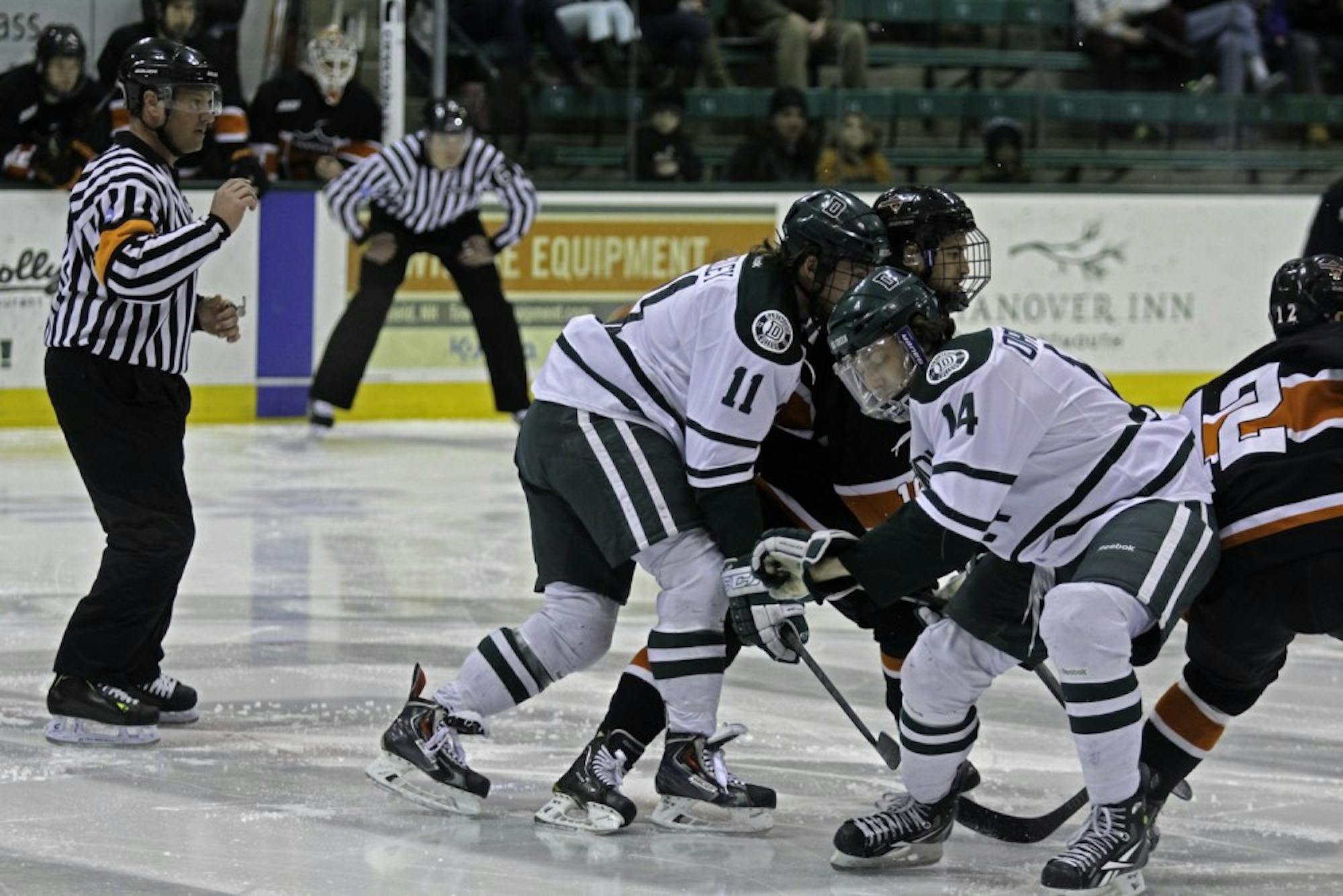 Eric Neiley '15 and Grant Opperman '17 battle for puck control in Thompson Arena.