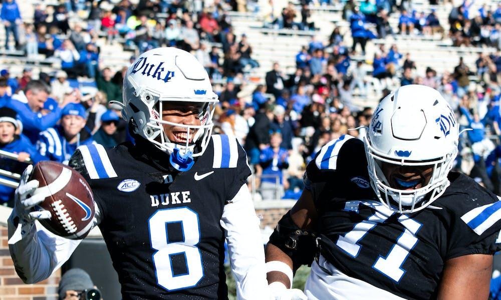 Jordan Moore (8) and Maurice McIntyre (71) celebrate a touchdown in Duke's win against Pittsburgh Nov. 25, 2023. 