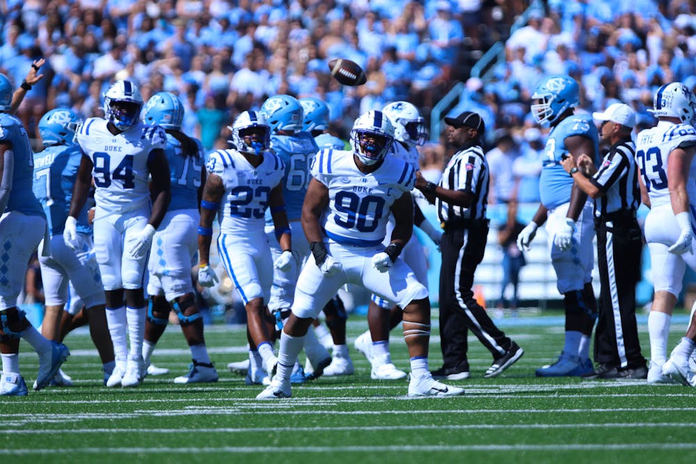 DeWayne Carter (center) led the Blue Devils with 1.5 sacks and two tackles for loss. 