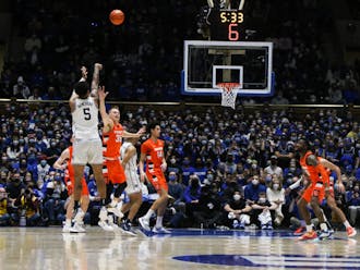 Forward Paolo Banchero shoots a 3-pointer against Syracuse. Four Blue Devils scored 15 points in Saturday's game.