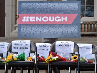 The #Enough sign includes the names of the recent shootings in America.