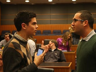 Duke Student Government members converse before their meeting Wednesday. The Senate voted last night to postpone the election for the DSG executive board to April 6.