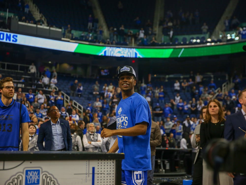 <p>Duke captain Jeremy Roach looks to the crowd during Duke's on-court celebration of its ACC title.</p>