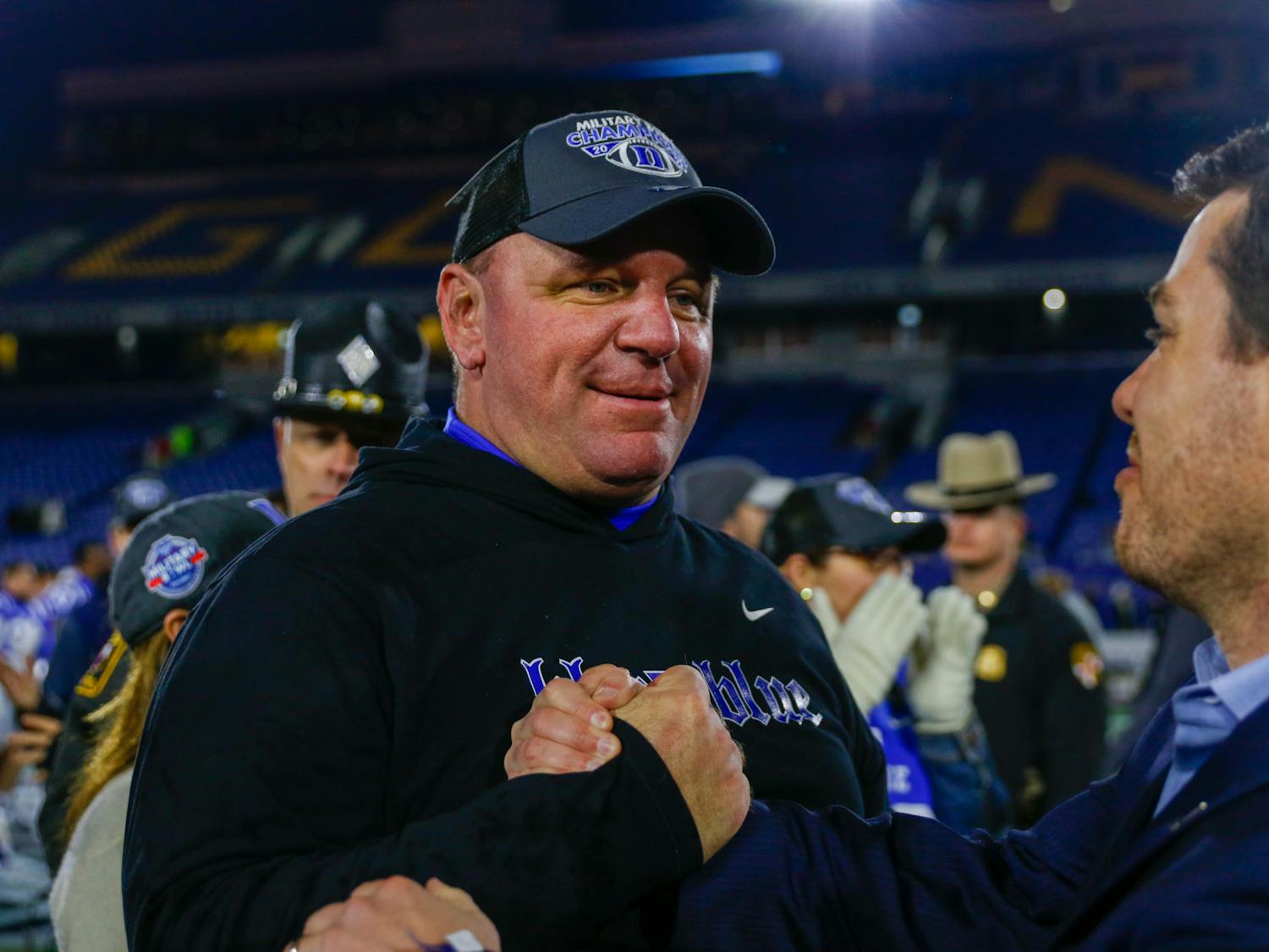 Mike Elko celebrates with the Blue Devils on the field after winning the Military Bowl.
