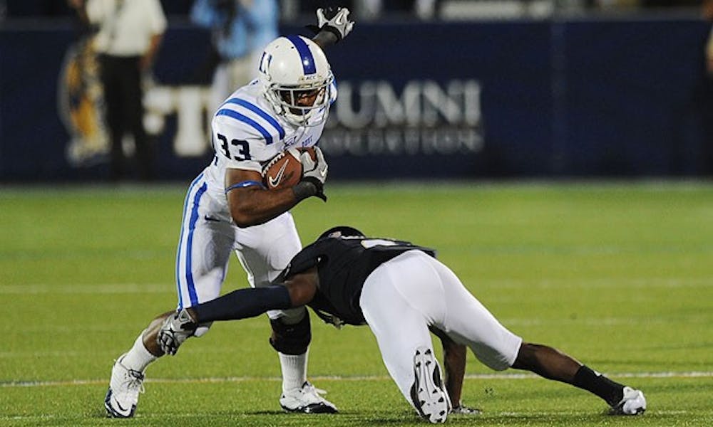 Duke running back Desmond Scott breaks a tackle midway through the Blue Devils’ comeback win over FIU.