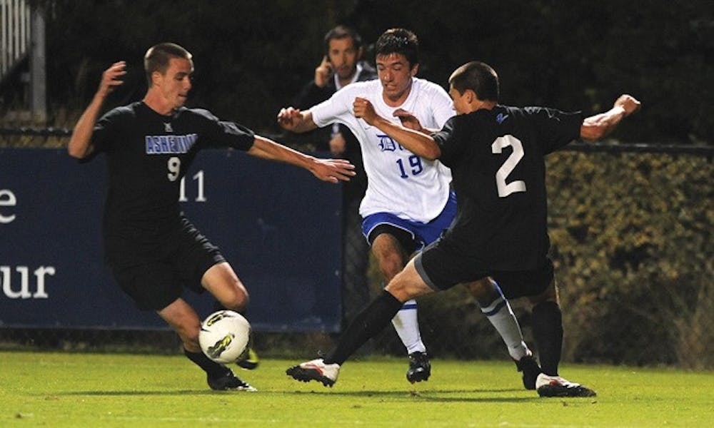 Senior Christopher Tweed-Kent splits a pair of UNC Asheville defenders Tuesday night. He scored twice in the contest to record the first multi-goal effort of his career.