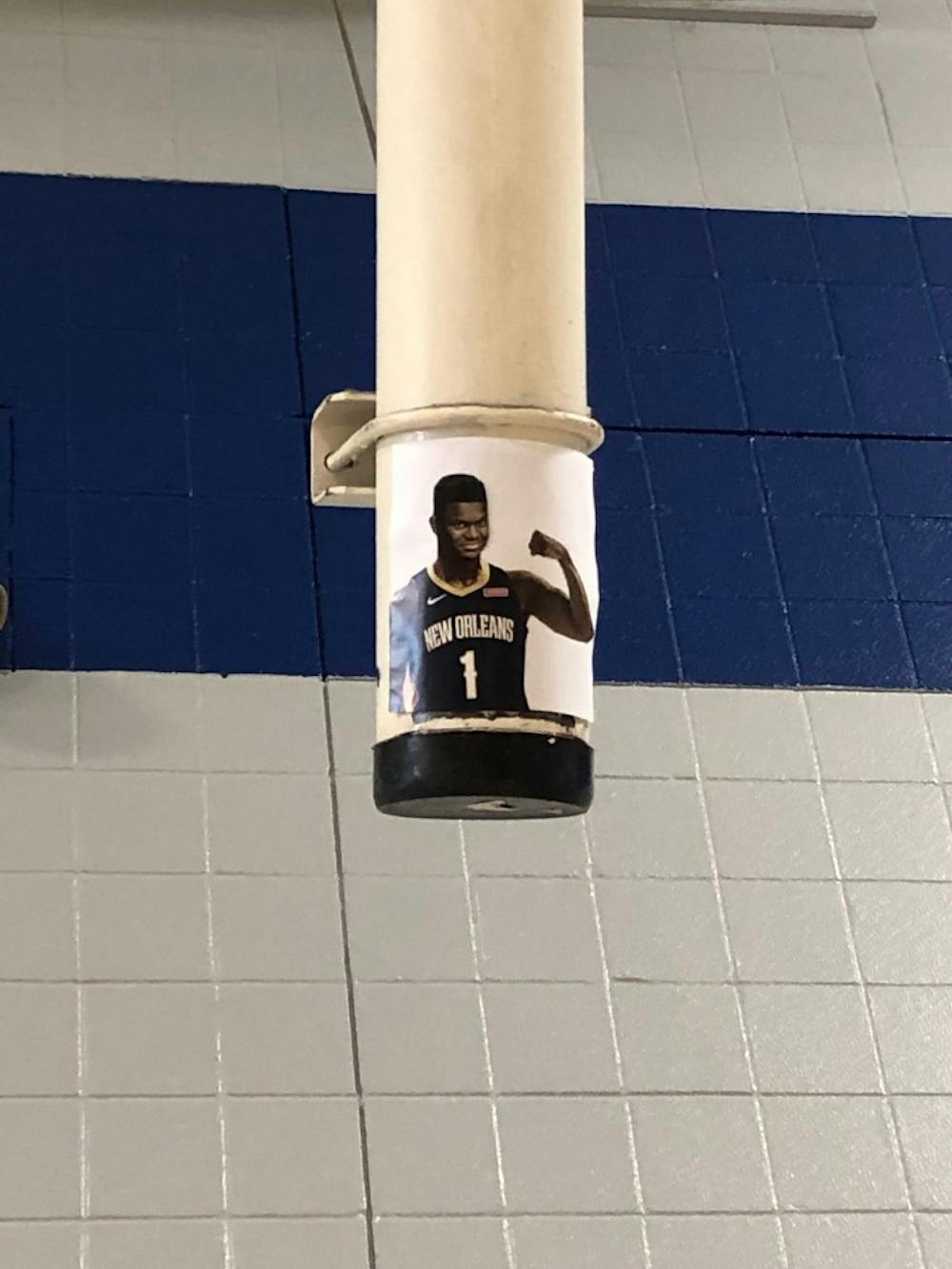 The image of a smirking Williamson ensures nobody will ever forget why pickup games on the first floor of Brodie Recreation Center are now limited to one full court