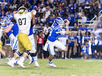 Quarterback Riley Leonard escapes pressure during Duke's loss to Notre Dame.