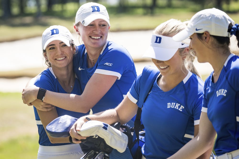 Andie Smith and Megan Furtney walk alongside Erica Shepherd (second from right) during Wolfpack Match Play at Lonnie Poole Golf Club.