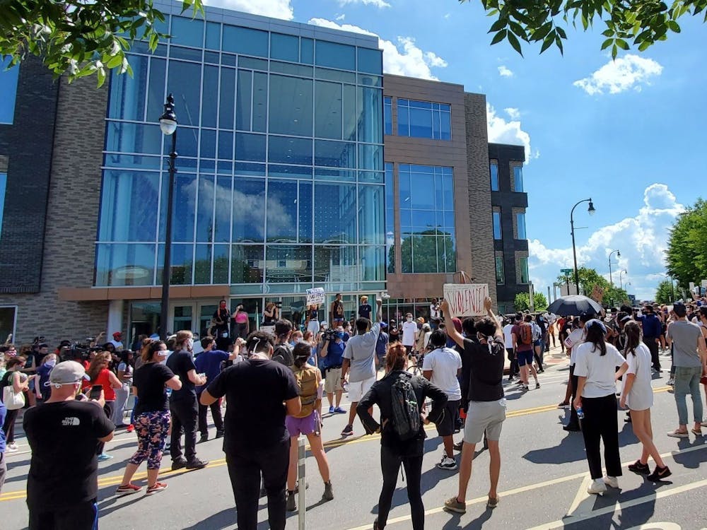 <p>A crowd protests George Floyd's death and police brutality outside the Durham Police Department headquarters Saturday.</p>