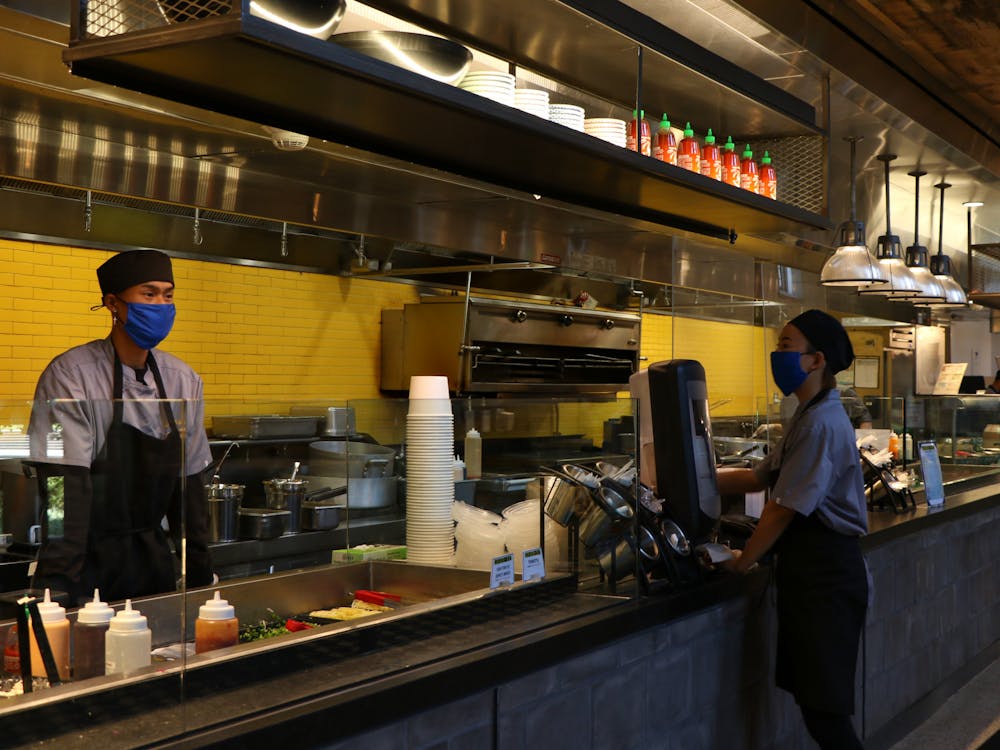 <p>Workers at Ginger &amp; Soy in the Brodhead Center.</p>