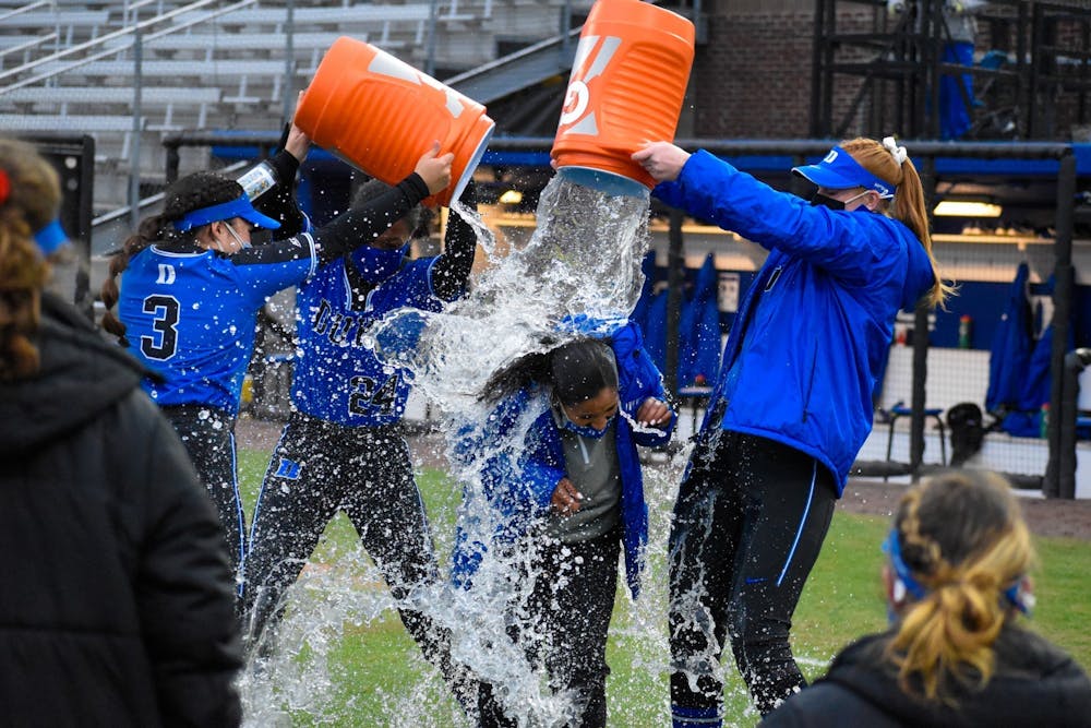 The softball team gave head coach Marissa Young a classic Gatorade shower after securing the 100th win in program history Saturday.