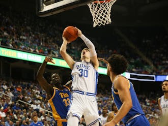 Kyle Filipowski shoots for two of his 14 first-half points Thursday against Pittsburgh inside Greensboro Coliseum.