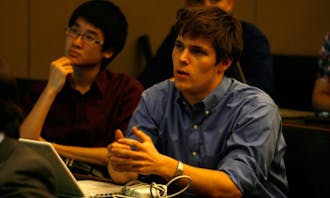 SOFC committee member Herng Lee (left) and Pete Schork, vice president for athletics and campus services, debate whether DSG should revoke the Duke College Republicans’ charter.