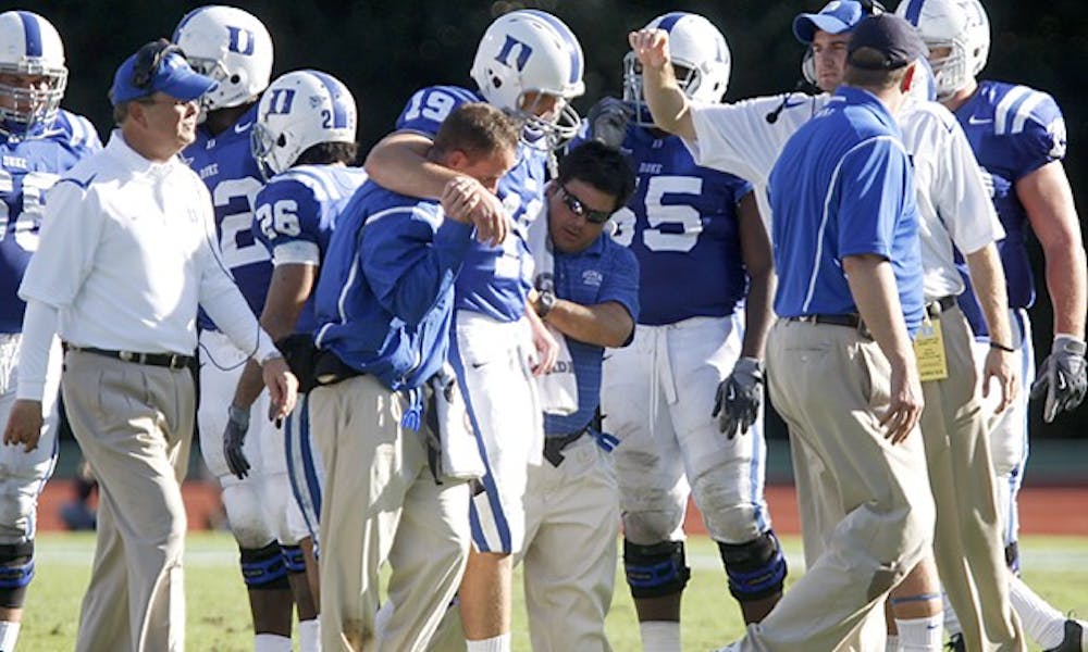 Sean Renfree (19, center) was helped off the field with a torn ACL Saturday afternoon.