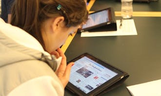 Richard Lucic, associate chair of the computer science department, has his students use iPads to learn the process of application development.