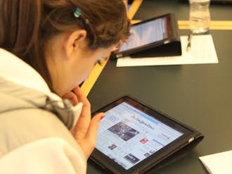 Richard Lucic, associate chair of the computer science department, has his students use iPads to learn the process of application development.