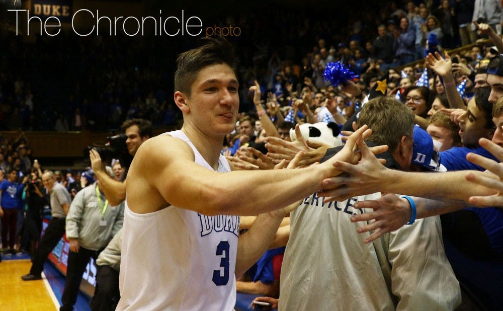 Grayson Allen high-fives the Cameron Crazies after his game-winner Saturday against Virginia.