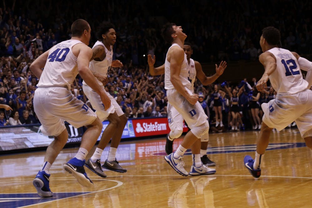 Teammates rush to mob Grayson Allen after his buzzer-beater Saturday against No. 7 Virginia.