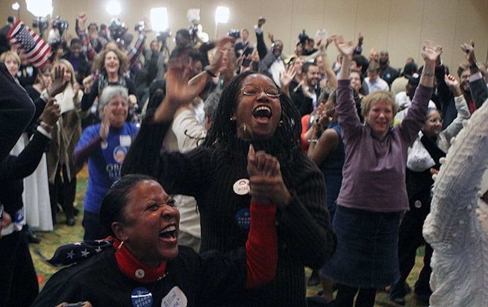 Local Democrats cheers as results roll in, showing a victory for President Barack Obama.