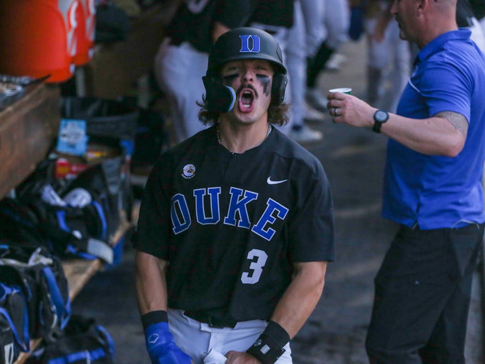 <p>Duke freshman Andrew Fischer celebrates in the dugout during the Blue Devils' blowout win against Campbell on April 4. The Manasquan, N.J., native set the school's freshman home run record with two against Boston College this weekend.</p>