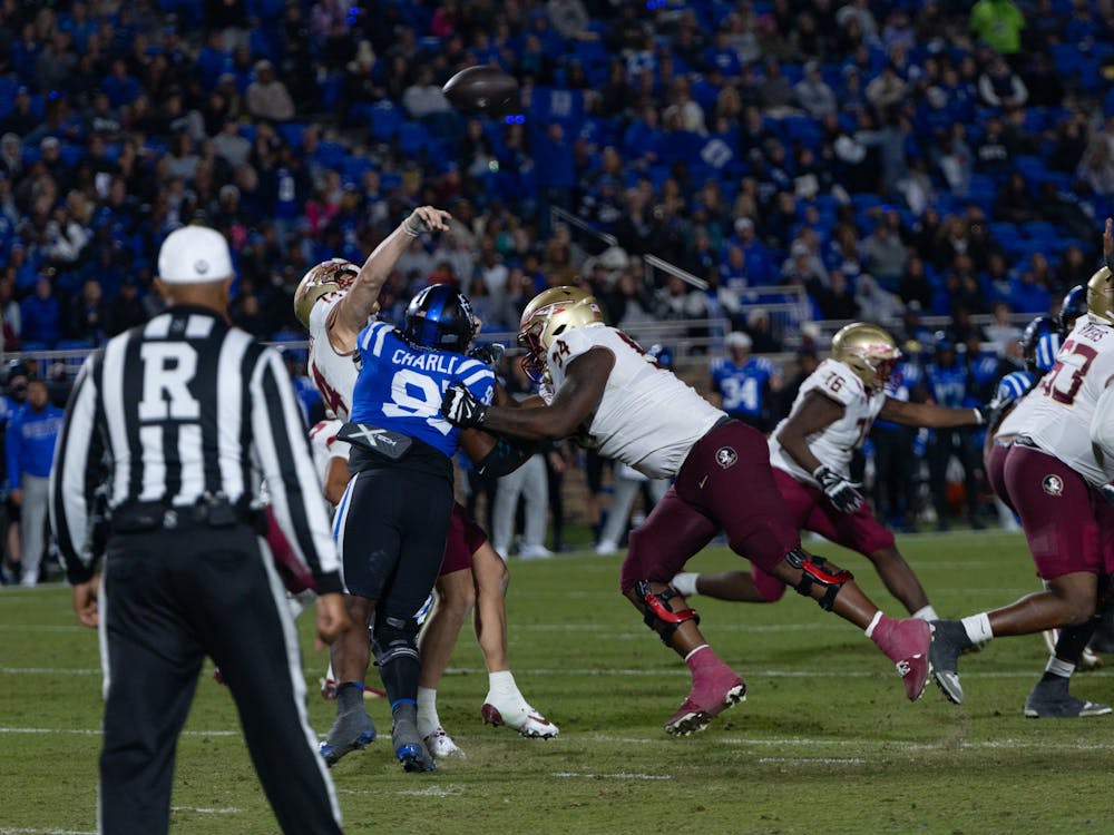 Kendy Charles gets pressure on Florida State quarterback Brock Glenn. 