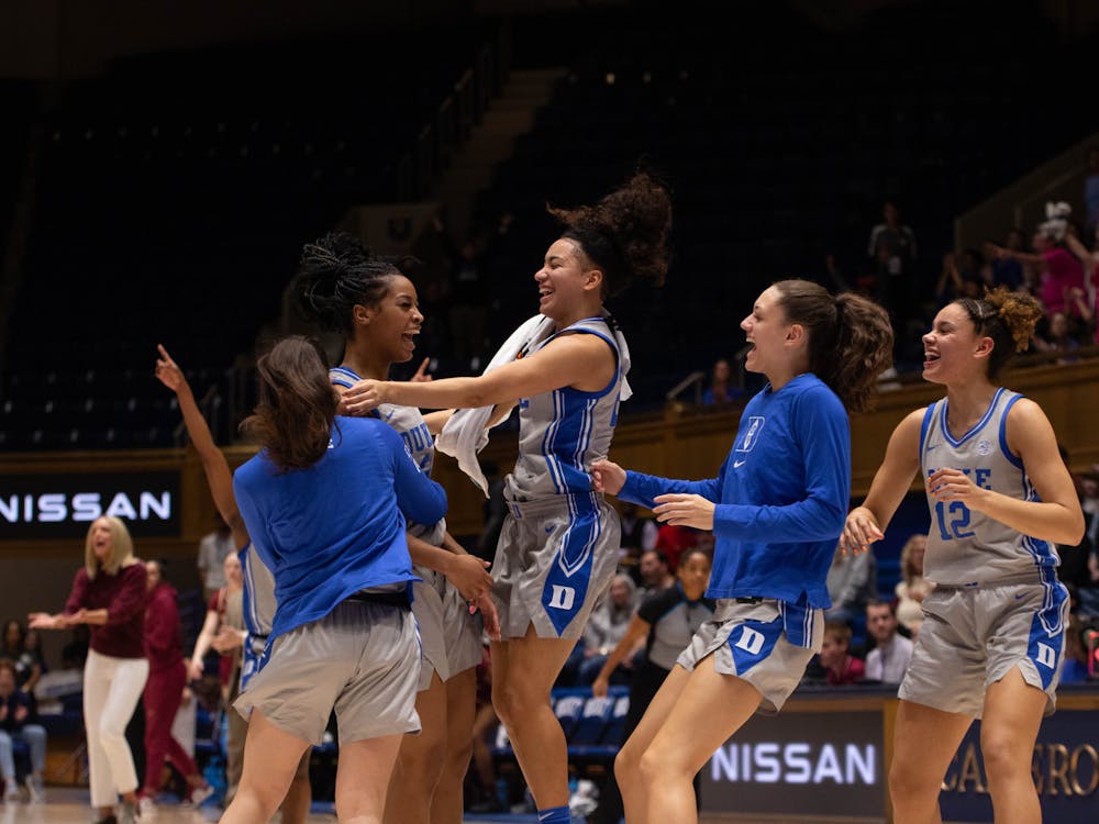 Multiple Blue Devils celebrate after an Ashlon Jackson bucket. 