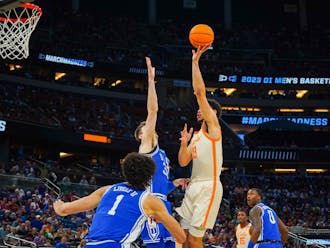 Kyle Filipowski contests a shot by Tennessee's Olivier Nkamhoua in the first half of Saturday's matchup in Orlando, Fla.