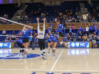 The Blue Devils celebrate after winning a point in their Sunday victory against Clemson.