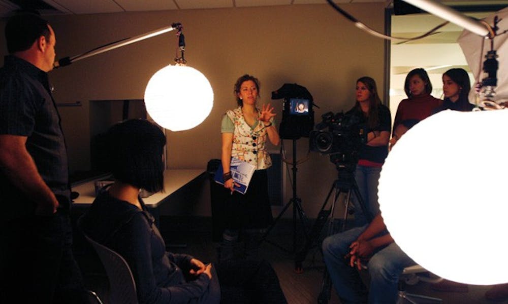 Amy Unell, Trinity '03, instructs a class of undergraduates on the process of filmmaking; Unell, a former Today Show producer, has been spearheading a documentary about former track coach Al Buehler since October.