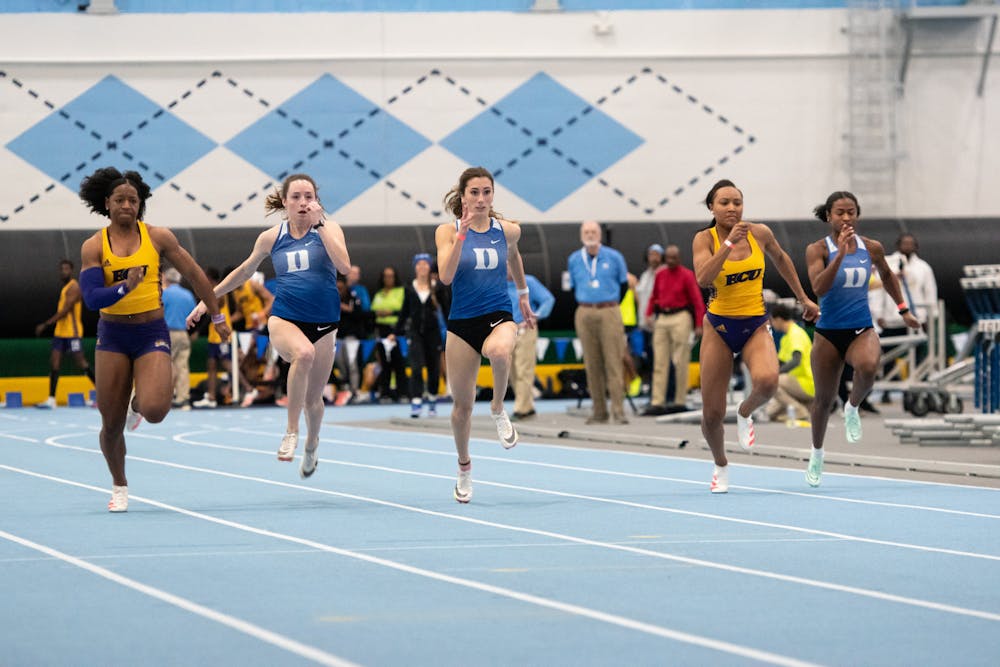 Sprinters race to the finish line inside Eddie Smith Fieldhouse as part of the Dick Taylor Carolina Challenge.
