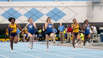 Sprinters race to the finish line inside Eddie Smith Fieldhouse as part of the Dick Taylor Carolina Challenge.