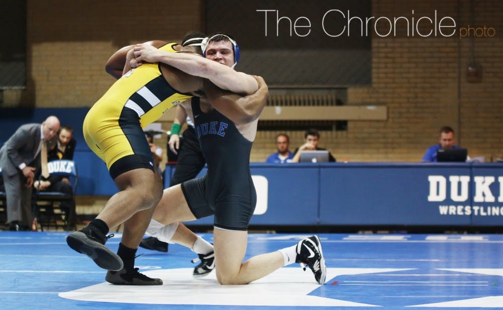 <p>The Blue Devils won two major decisions Sunday but could not overcome lopsided defeats in several weight classes.</p>