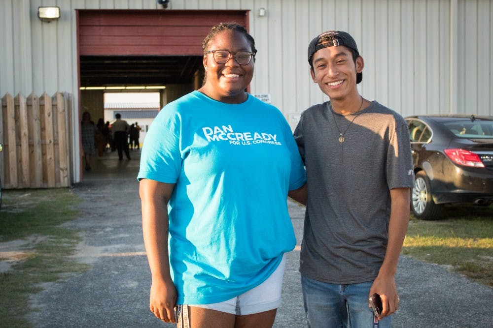 Peace Ajirotutu, left, and Brian Flores have volunteered with McCready's campaign and attended the Lumberton rally. 