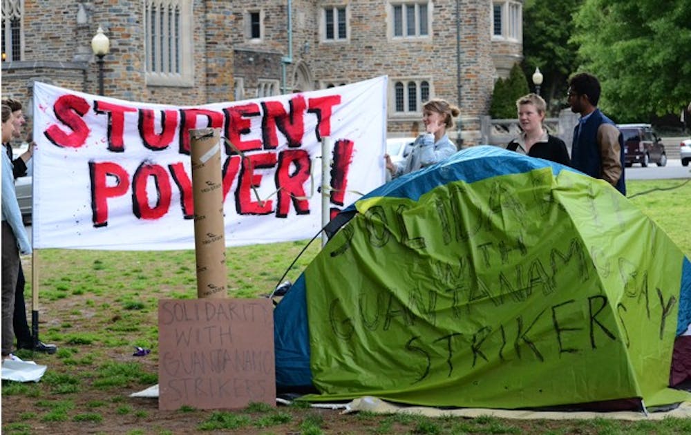 Students from Duke and UNC show support for a hunger strike among Guantanamo Bay prisoners on the Chapel Quad Monday. The protesters plan to occupy the quad indefinitely.