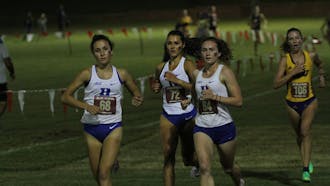 Sophomore Charlotte Tomkinson (center) finished 25th overall Friday.&nbsp;