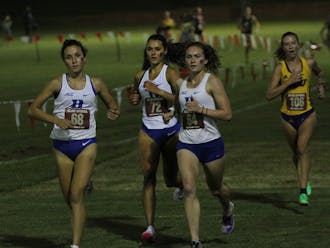Sophomore Charlotte Tomkinson (center) finished 25th overall Friday.&nbsp;