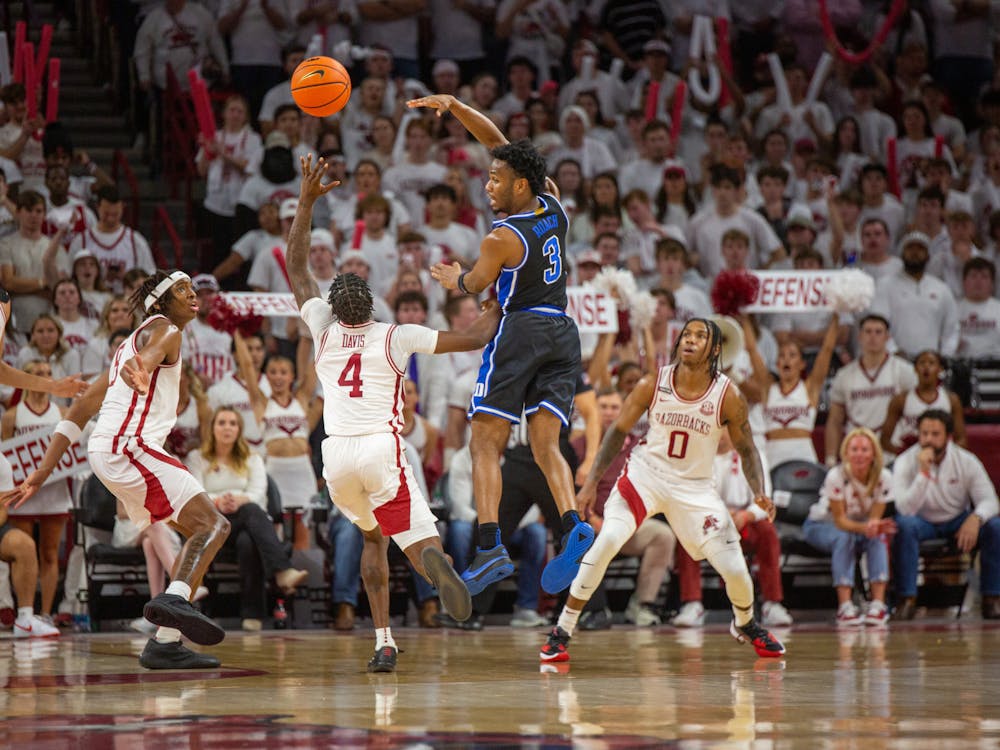 Senior guard Jeremy Roach flicks the ball to a teammate during the first half of Duke's clash with Arkansas.