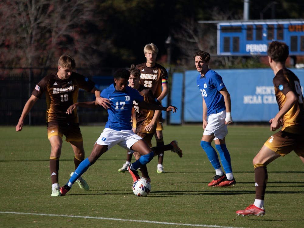 Midfielder Wayne Frederick skillfully shields the ball from a defender