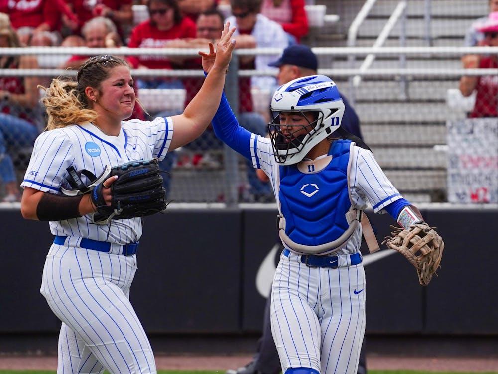 Cassidy Curd (left) celebrates with catcher Kelly Torres (right) during the Blue Devils' NCAA tournament series against Stanford.