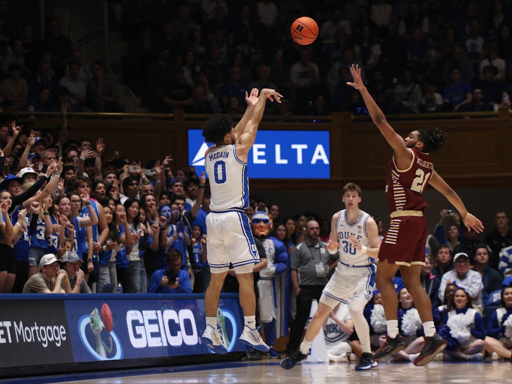 Jared McCain lofts a 3-pointer over a Boston College defender in Duke's Saturday afternoon win.
