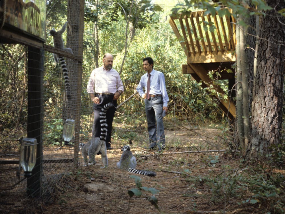 <p>Elwyn Simons, then-Duke University Primate Center Director (left), with a visitor (right) in 1982.</p>