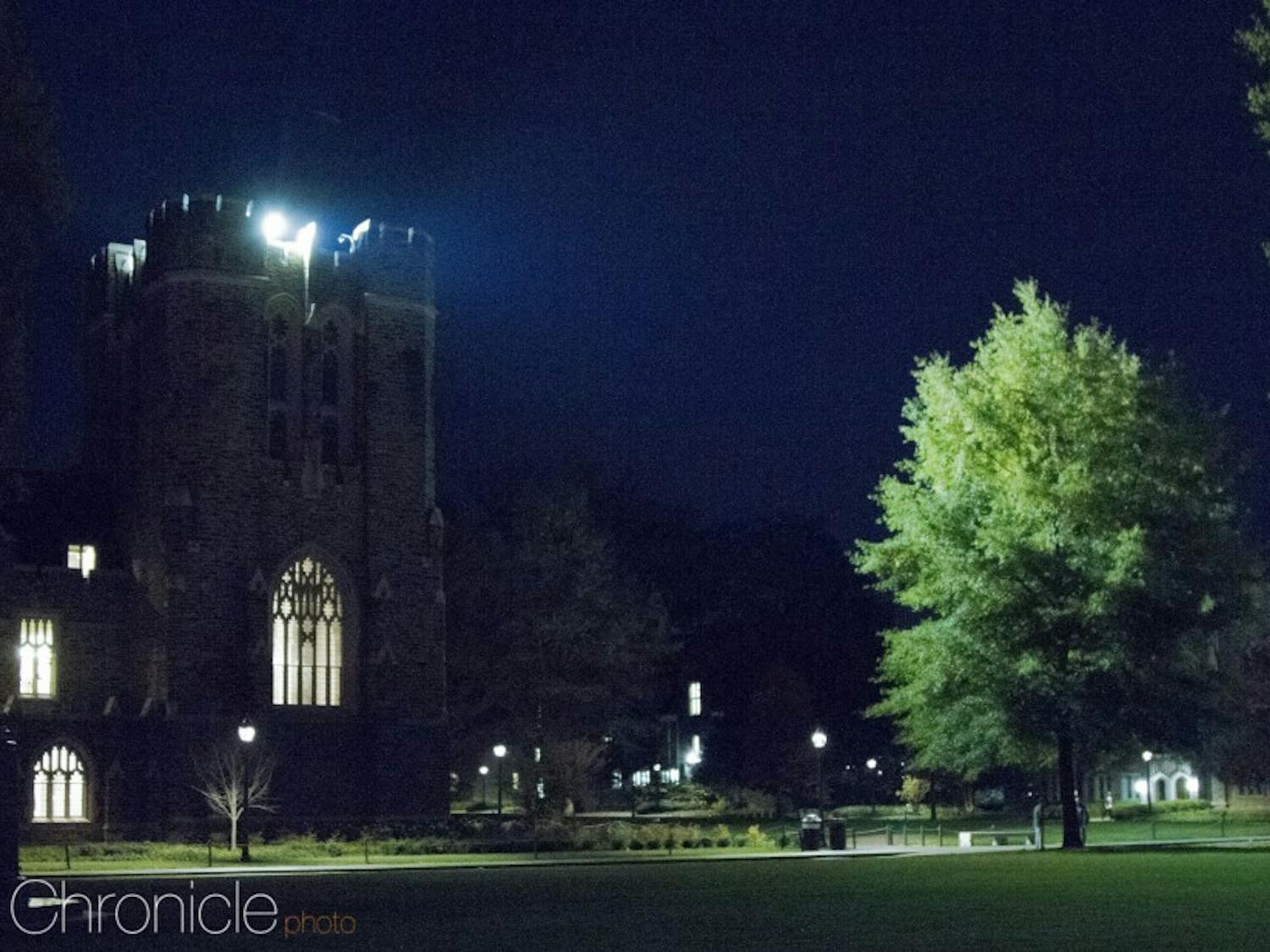 The spotlight on top of Rubenstein Library brightens Abele Quad.