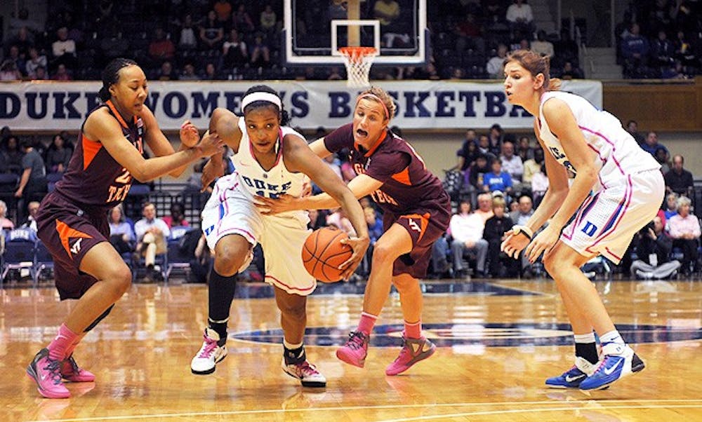 Committing one of its 35 fouls Wednesday, Virginia Tech grabs Richa Jackson, who later left the game injured.
